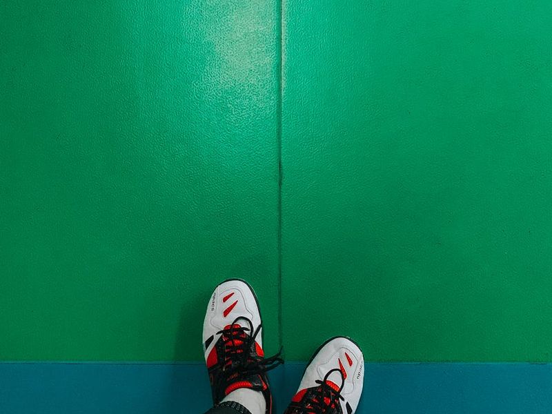 Detailed view of sneakers and gym floor background